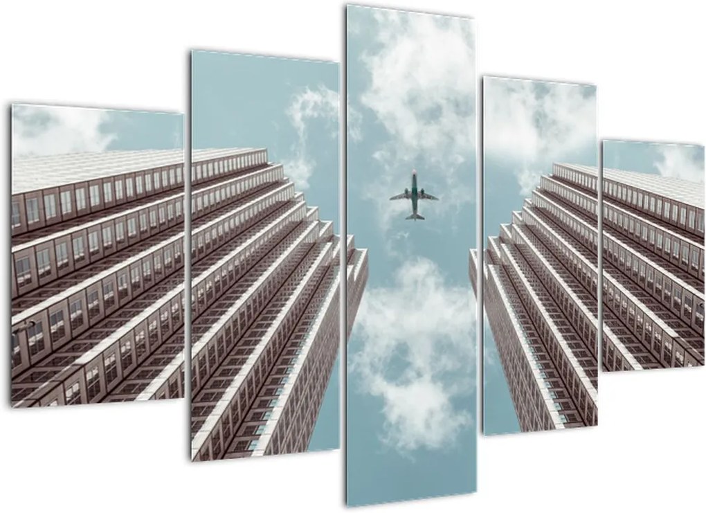 Schilderij - Vliegtuig boven gebouwen (150x105 cm), 40 andere afmetingen