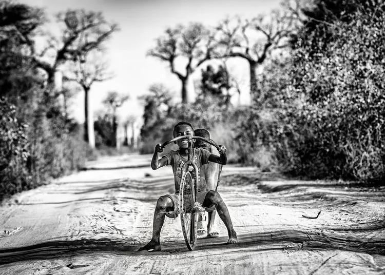 Fotobehang Having fun among baobabs, (128 x 96 cm)