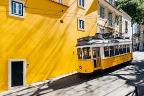 Foto Yellow tram moving past yellow building, Alexander Spatari