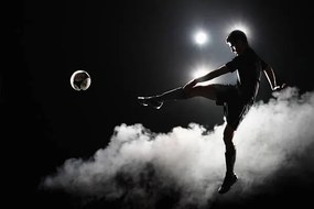 Foto Soccer player kicking the ball at night on stadium, Stanislaw Pytel