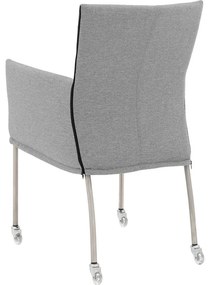Goossens Eetkamerstoel Funk RVS Poten grijs stof met armleuning en met wielenTransparant skater wiel met rvs kap, modern design